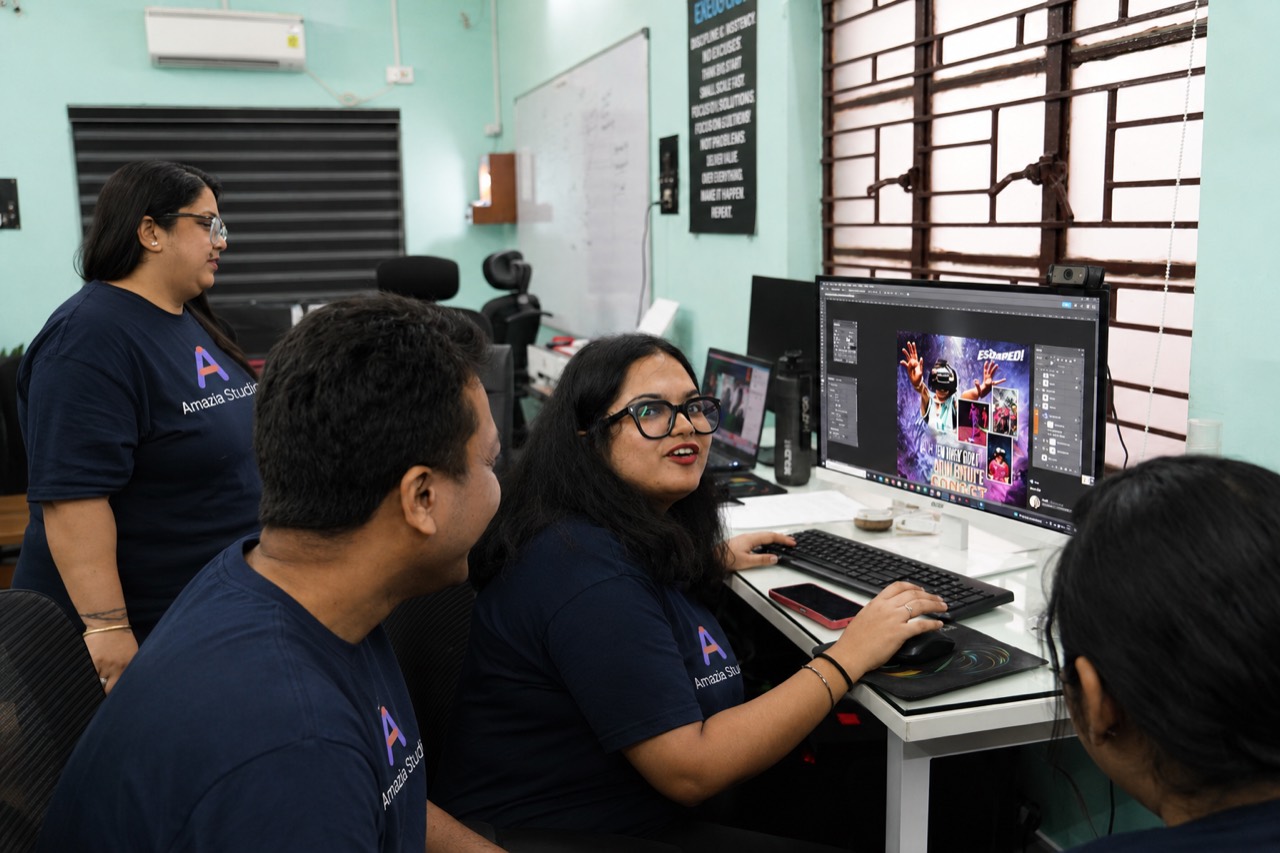 Two members of the Amazia Studio team reviewing an app design together at a screen