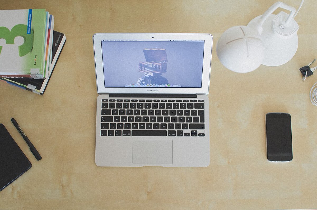 A laptop open on a tidy wooden desk in a calm workspace